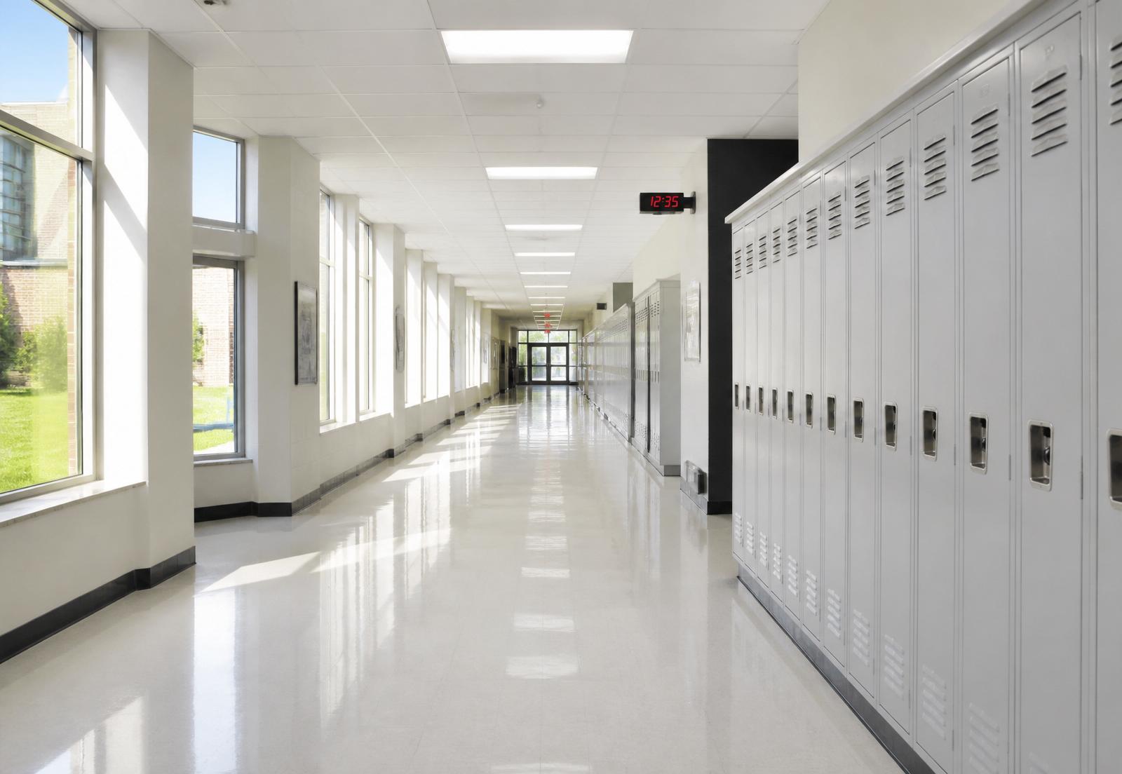 Sunlit school hallway lined with lockers